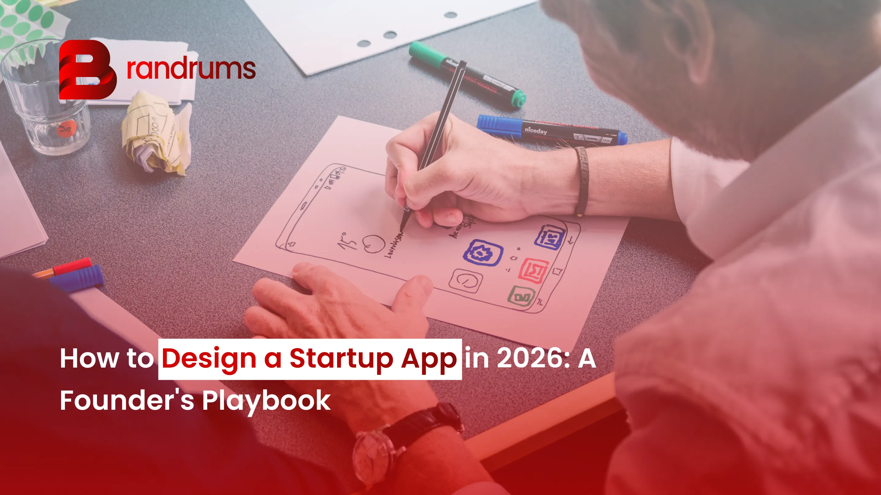 Founder and designer sketching a startup app flow on a whiteboard with a laptop showing Figma wireframes