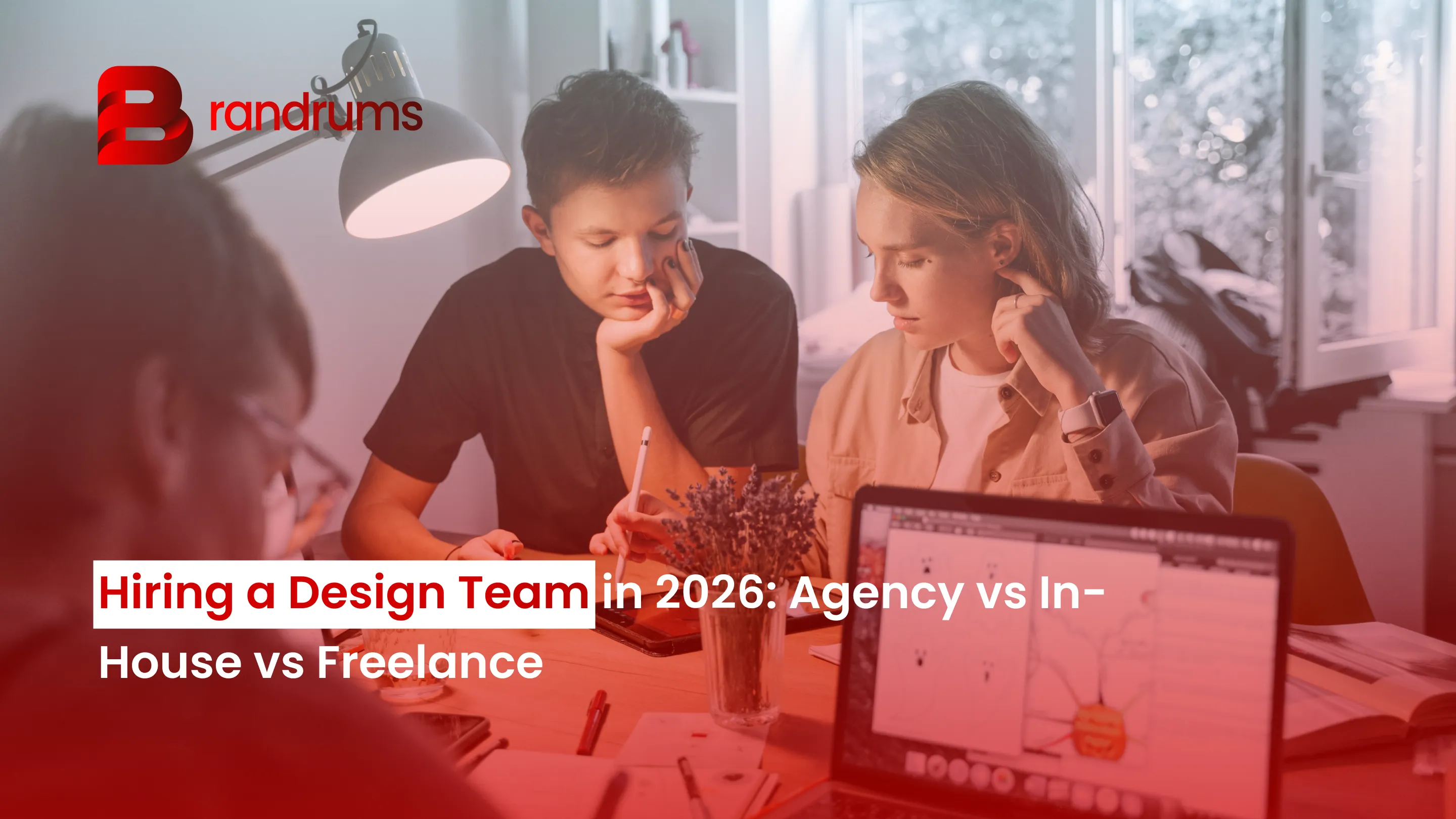 Read: Hiring a Design Team in 2026: Agency vs In-House vs Freelance Founder reviewing design portfolios on laptop while evaluating agency, in-house, and freelance hiring options